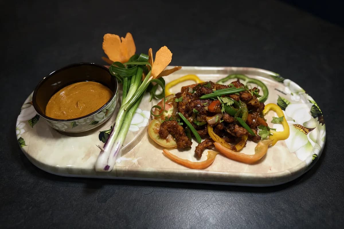 Classic Chilli Chicken: dry chilli chicken with tri-colour peppers and spring onion