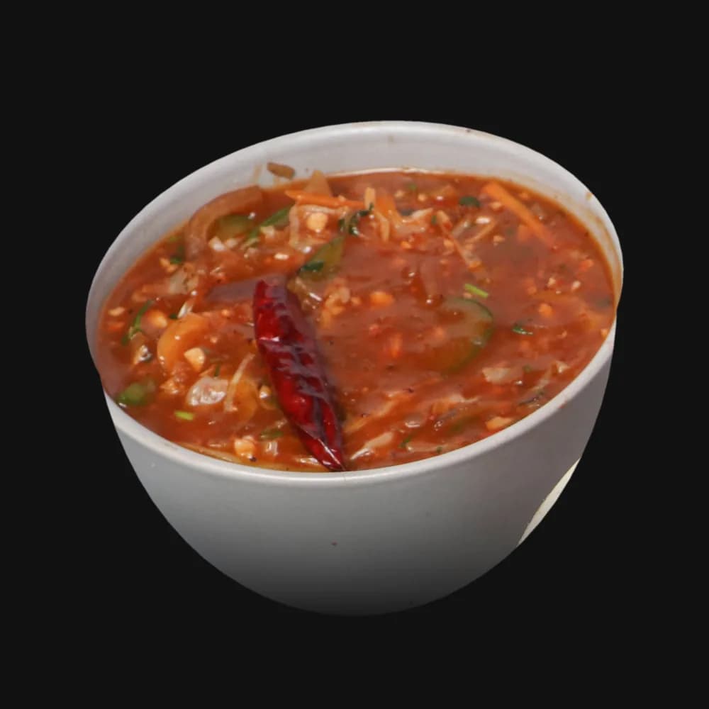 A bowl of fiery red chilli sauce with a dried chilli (Dragon Fire Upgrade)