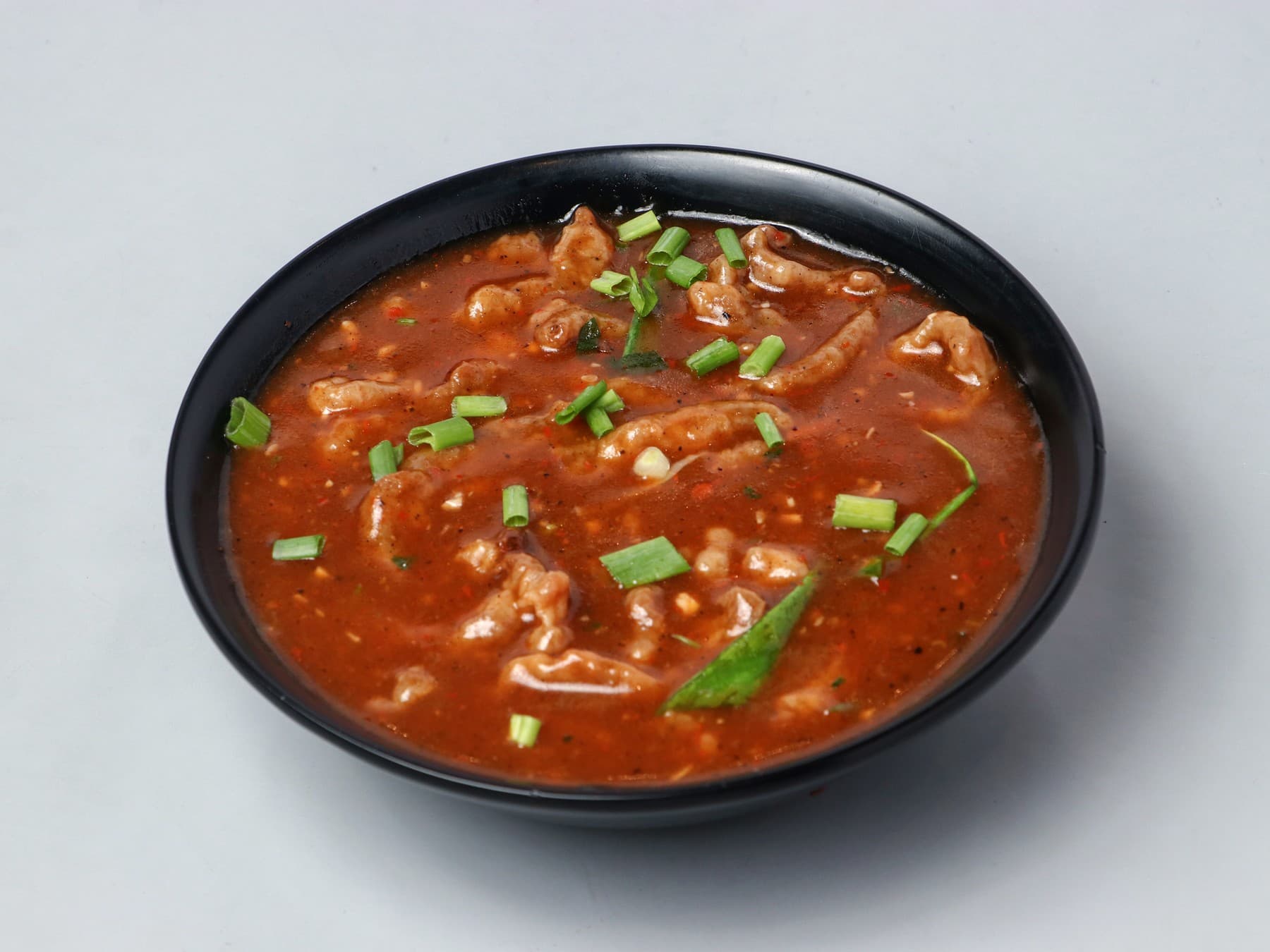 Shredded crispy lamb in a thick, dark oyster-sauce broth with spring onion