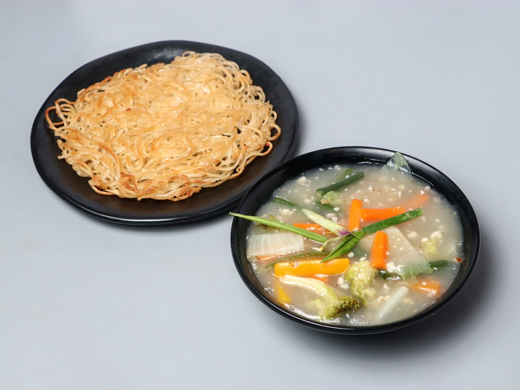 Crisp pan-fried noodle cake with a vegetable gravy